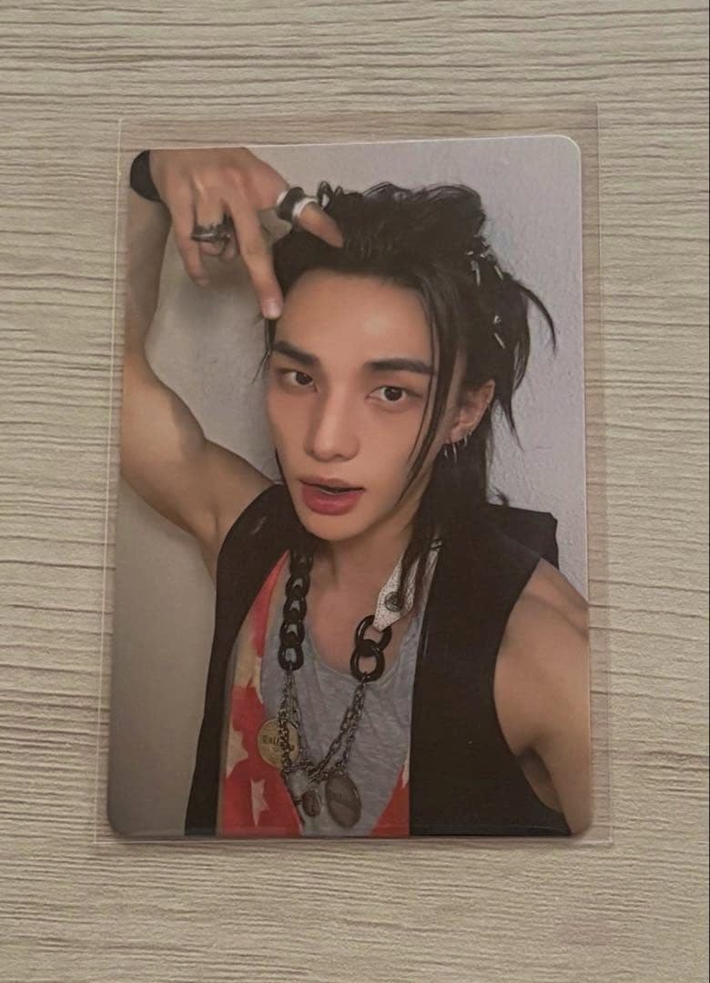 Front of the photocard showing a person wearing layered necklaces and a sleeveless top.