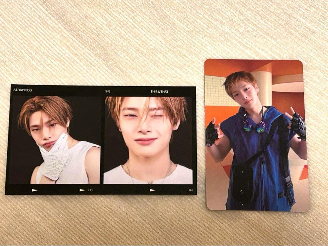 Two photocards on a textured background: a double-frame black portrait card at left and a single portrait photocard showing a person in a blue outfit at right.