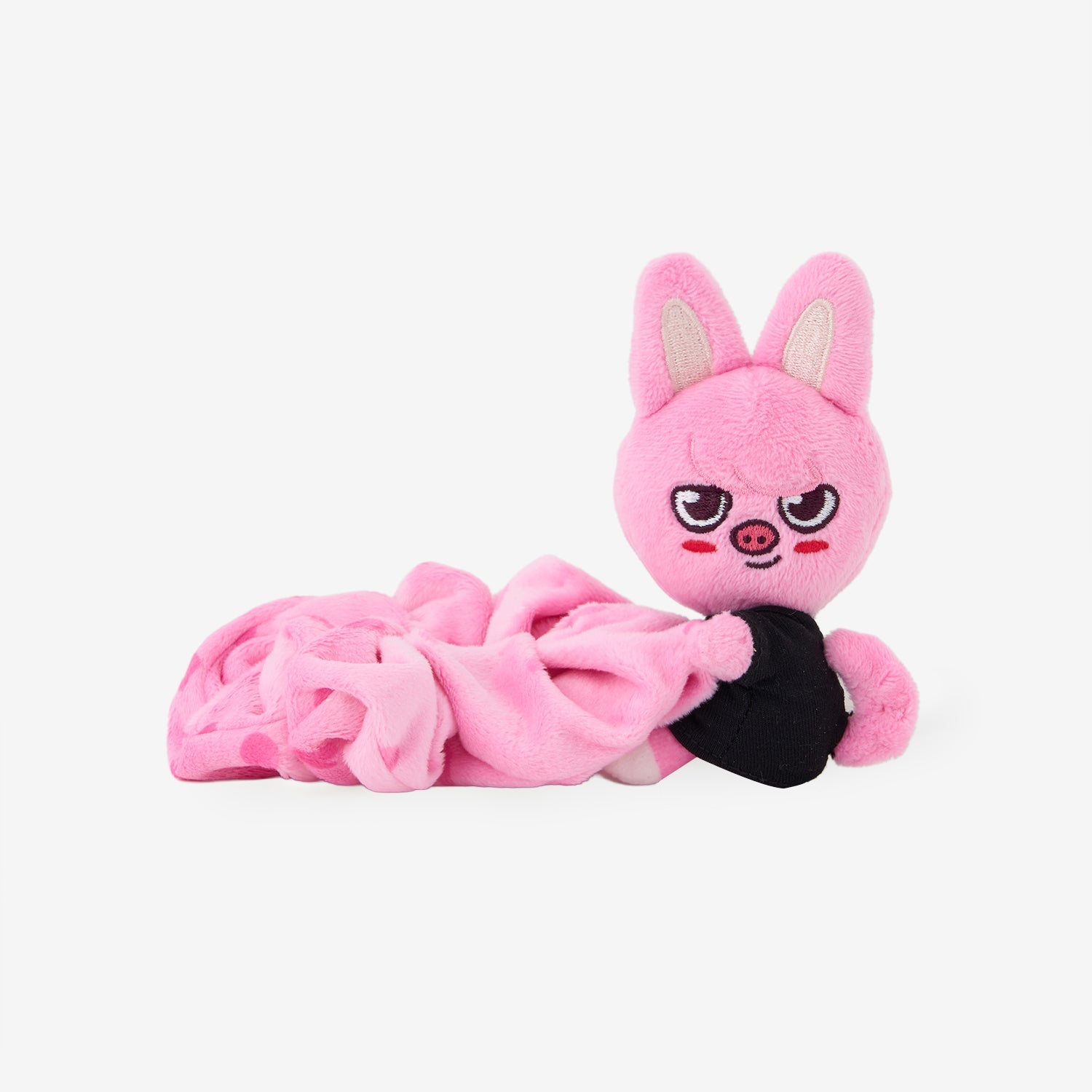 Pink scrunchie hair band with an attached plush character head shown lying on a white background.