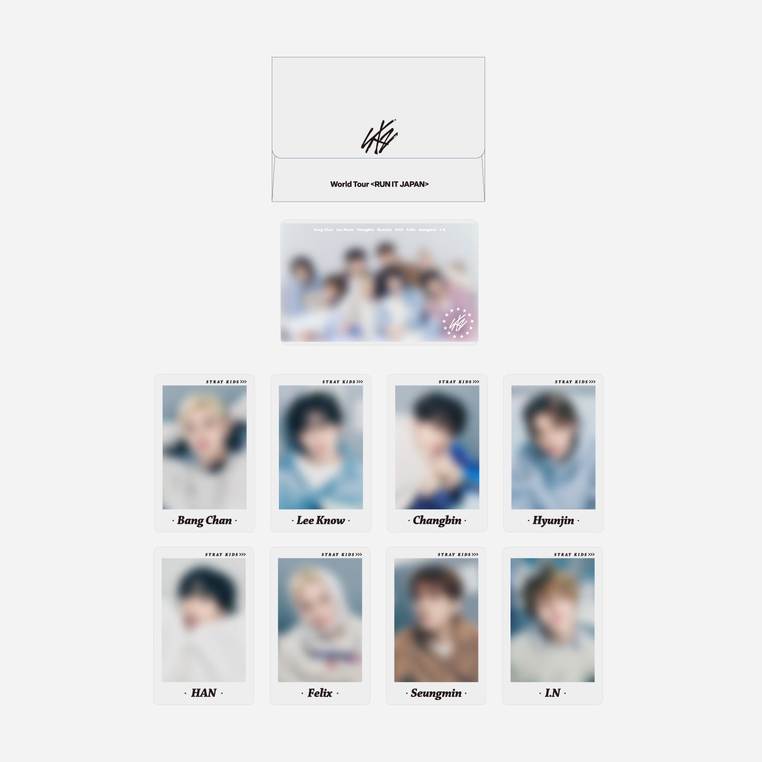 Display of the Stray Kids 'World Tour <RUN IT JAPAN>' photocard set showing the envelope, a group photo card, and nine individual member photocards.