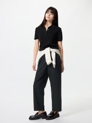 Model wearing the women's linen ankle-length pants, front view, with a sweater tied at the waist.