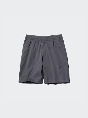 Flat-lay photo of men's stretch easy shorts in dark gray on a light background.