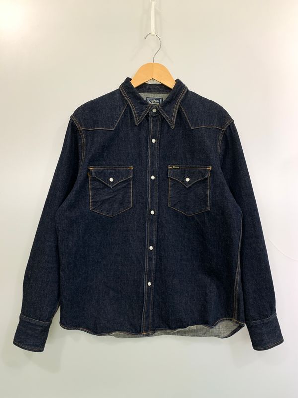 Front view of a STUDIO D’ARTISAN denim western long-sleeve shirt hanging on a wooden hanger.