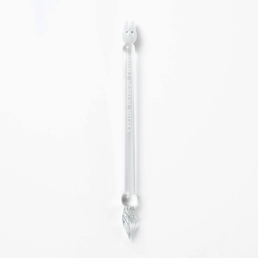 Clear glass dip pen with a Totoro-shaped top and engraved "GHIBLI MUSEUM · MITAKA" shown on a white background.