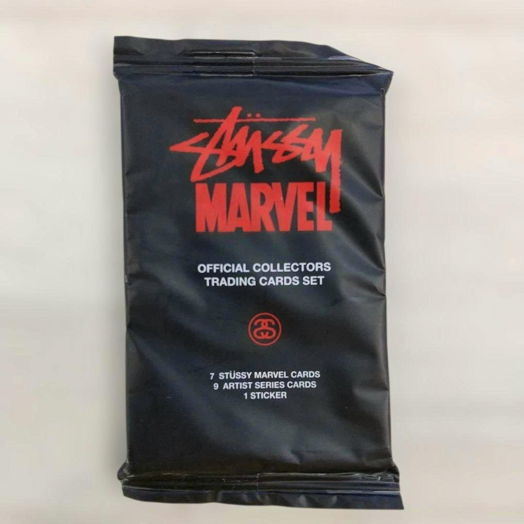 A sealed black Stussy × Marvel trading cards pack showing the STUSSY MARVEL logo and text reading "OFFICIAL COLLECTORS TRADING CARDS SET".
