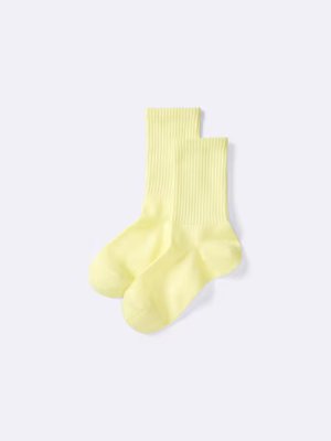 Pair of light yellow high-ankle ribbed men's socks on a white background.
