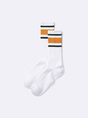 White high-ankle socks with orange and dark green horizontal stripes on a plain light background.