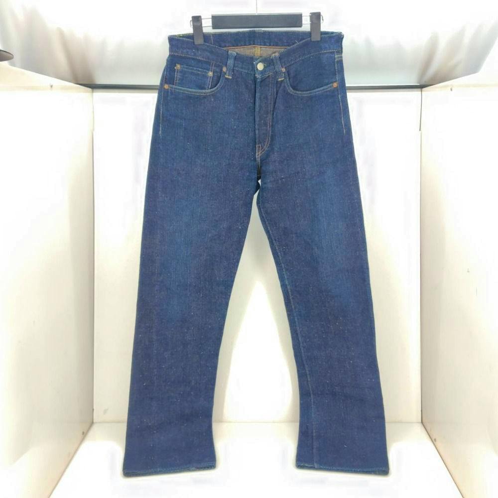 Front view of the indigo Sugar Cane men's denim pants (Lot.301, W32 L34) hanging on a clip hanger.