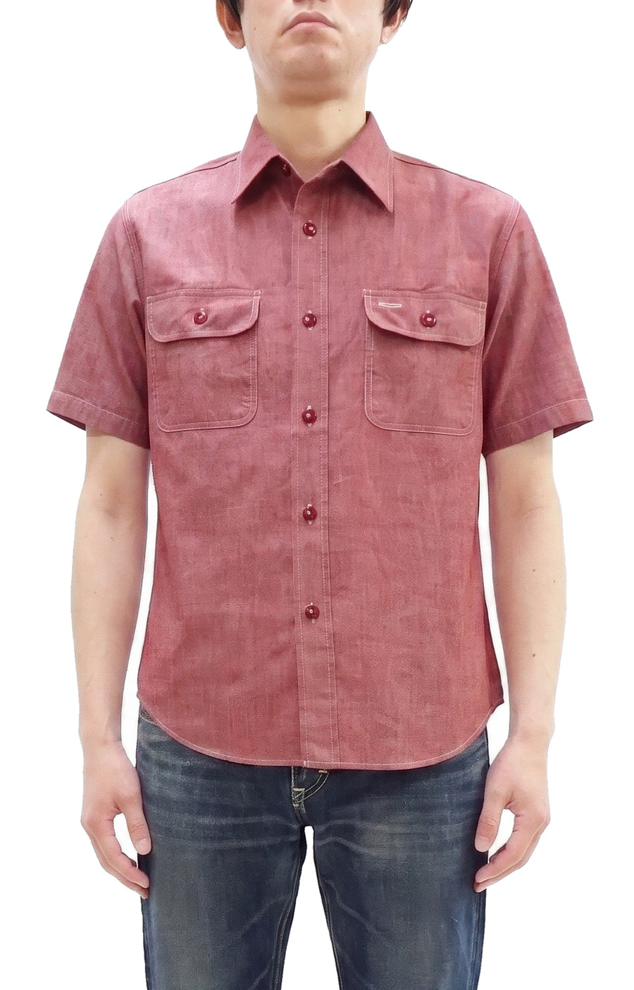 Front view of a Sugar Cane red chambray men's short-sleeve cotton work shirt worn by a model.