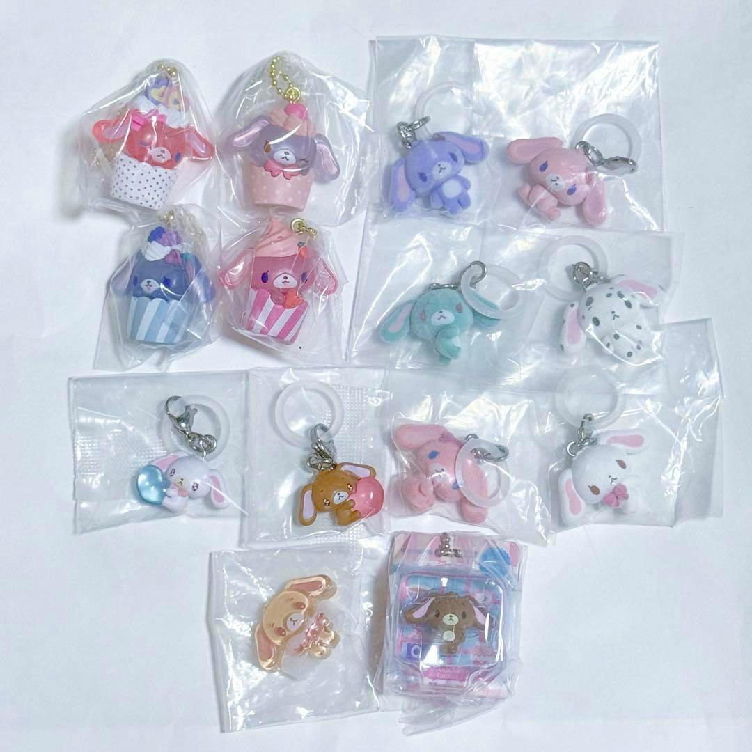 Multiple Sugar Bunnies gacha keychain accessories in sealed plastic bags arranged on a white background.