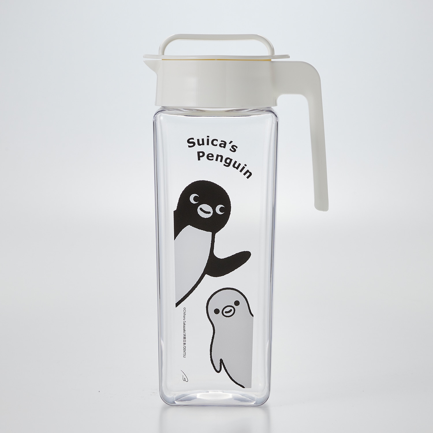 Clear plastic bottle with a white handle and Suica's Penguin character print on a plain background.