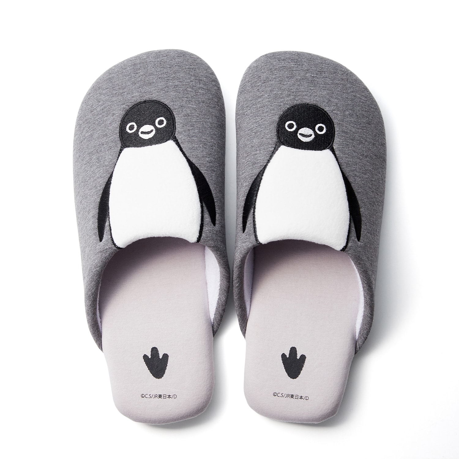 Top view of gray slippers featuring the Suica penguin embroidered with a padded white belly and penguin footprint on the insoles.