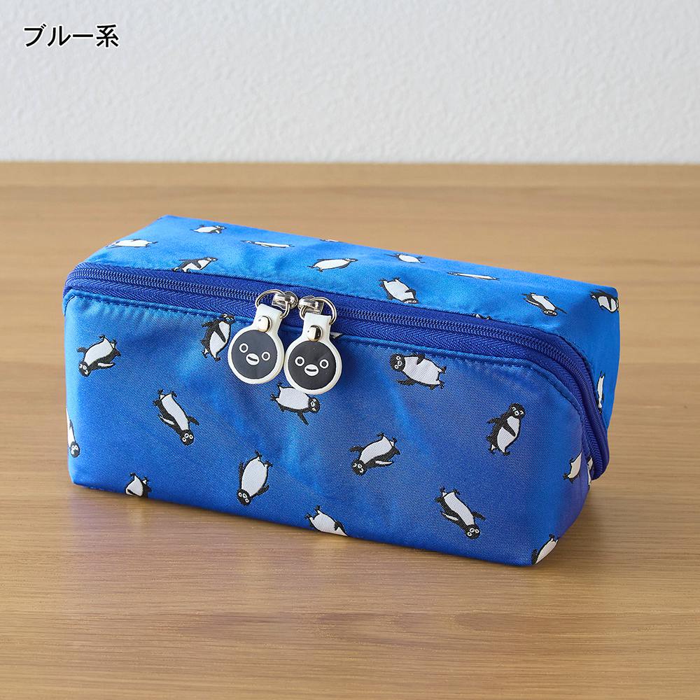 Blue pouch with Suica penguin pattern and round penguin-face zipper pulls on a wooden surface.