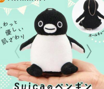 Palm-sized Suica penguin plush toy sitting in a person’s hand, front view.