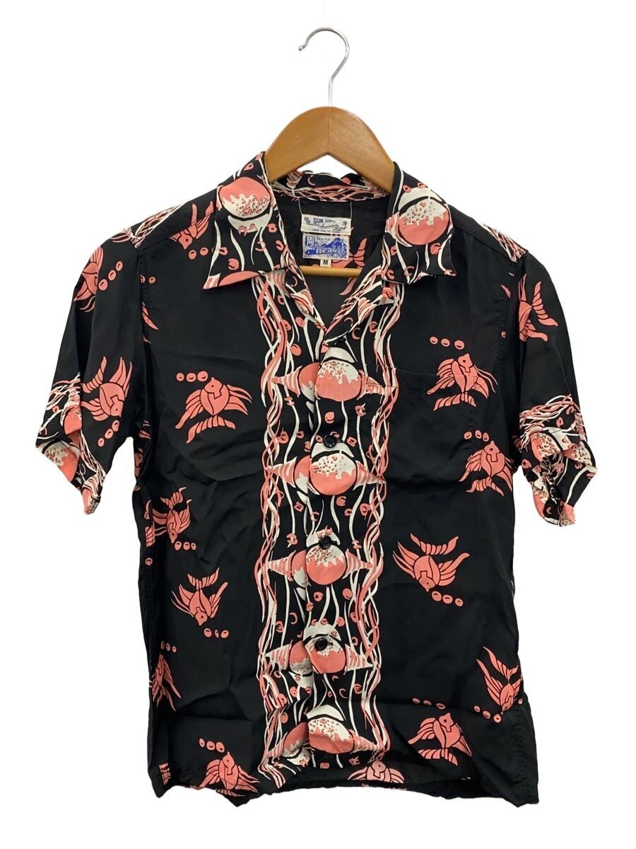Black rayon SUN SURF aloha shirt with pink floral pattern hanging on a wooden hanger against a white background.