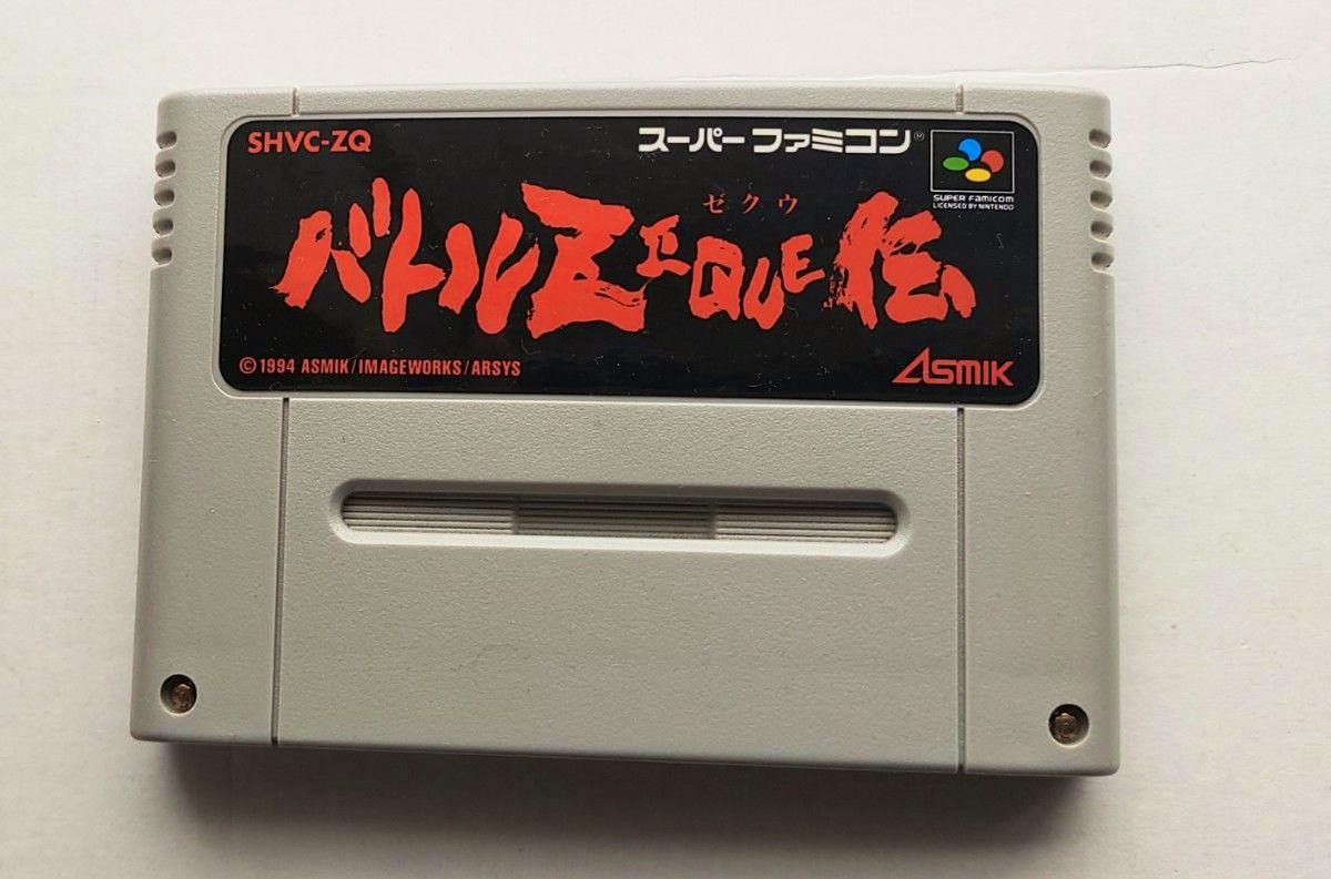 Front of a Super Famicom game cartridge showing the バトルゼクウ伝 label and the Asmik logo.