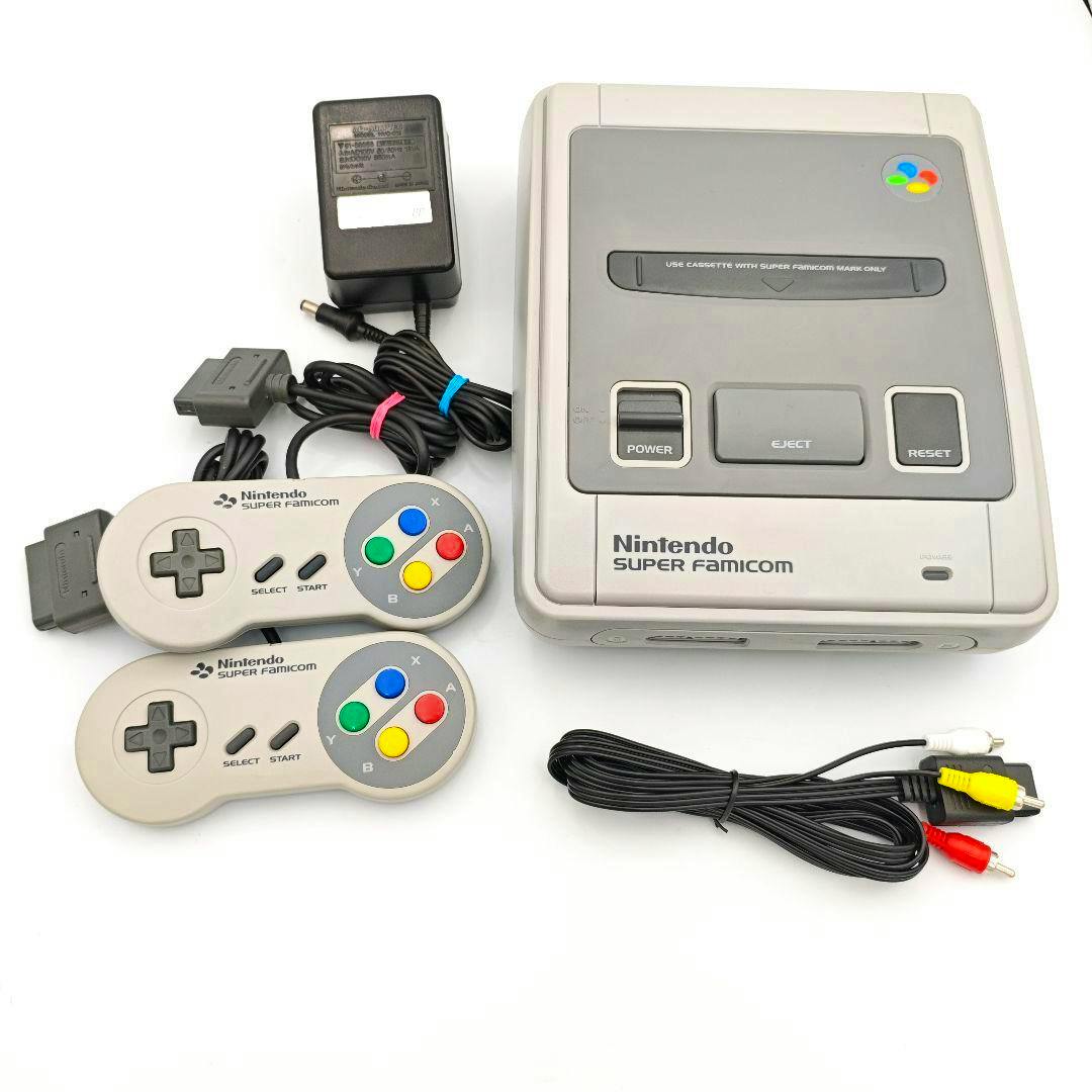 Super Famicom console set shown with the Super Famicom main unit, two controllers, a power adapter, and AV cable on a white background.