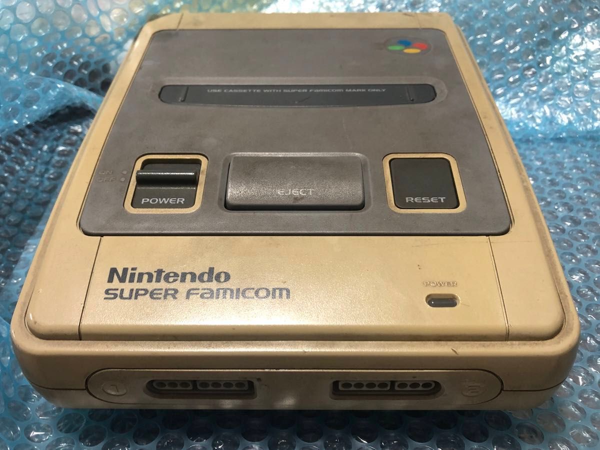 Front view of the Super Famicom console showing the power and reset buttons and dual controller ports.