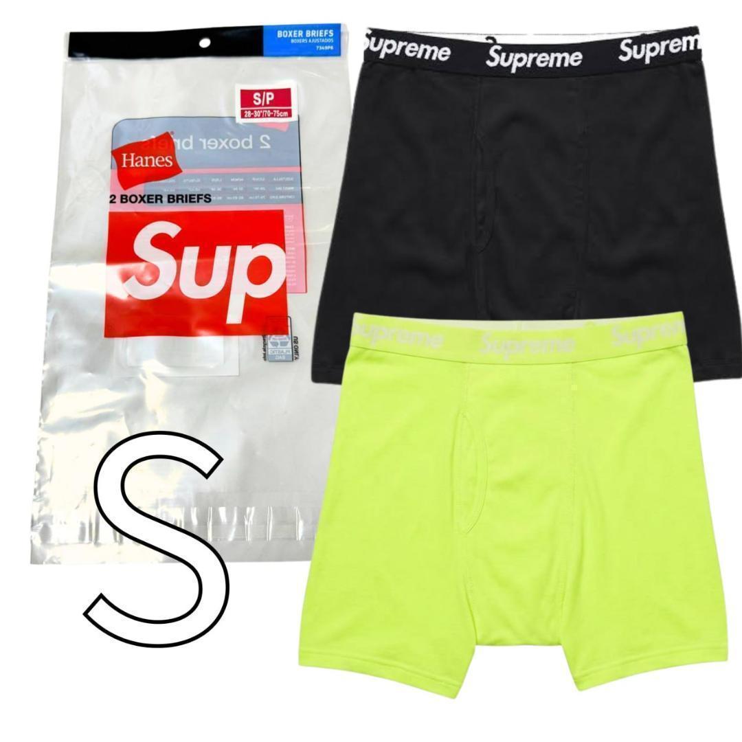 Two boxer briefs (black and neon green) displayed next to Hanes/Supreme product packaging marked size S.