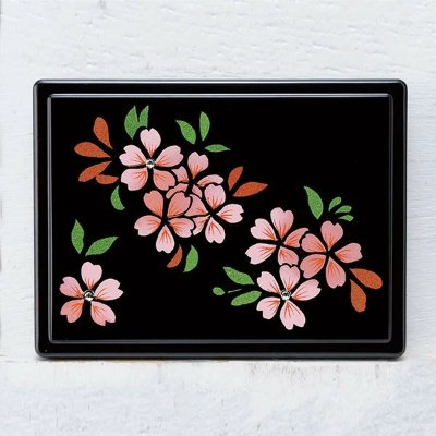 Black rectangular post-it case decorated with pink cherry blossom flowers and green leaves.