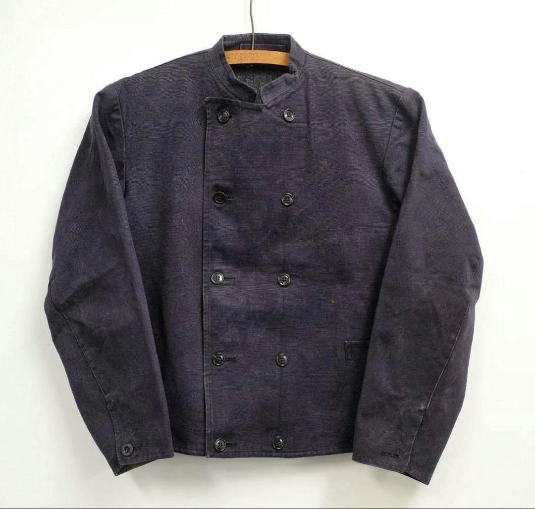 Front view of a dark Swedish military men's cotton woven jacket hanging on a hanger against a white background.