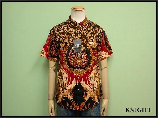 Mannequin wearing a men's cotton batik short-sleeve shirt showing the front pattern and SYL tag.