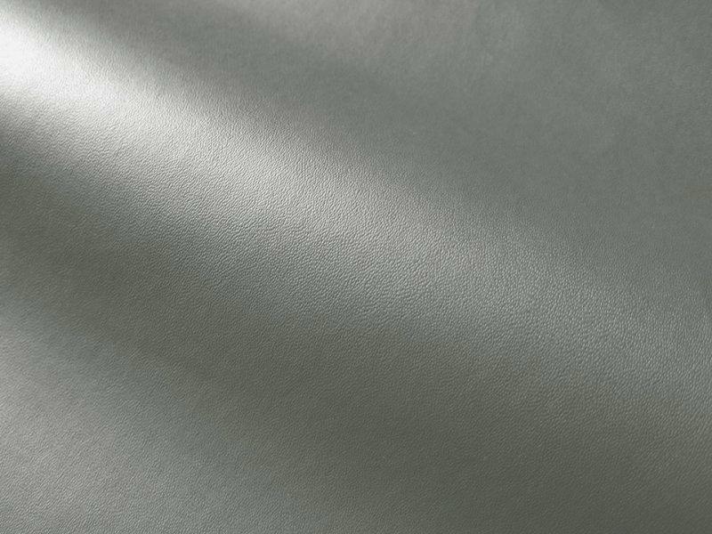 Close-up of grey thin matte synthetic leather (polyester) fabric showing texture and a slight drape.
