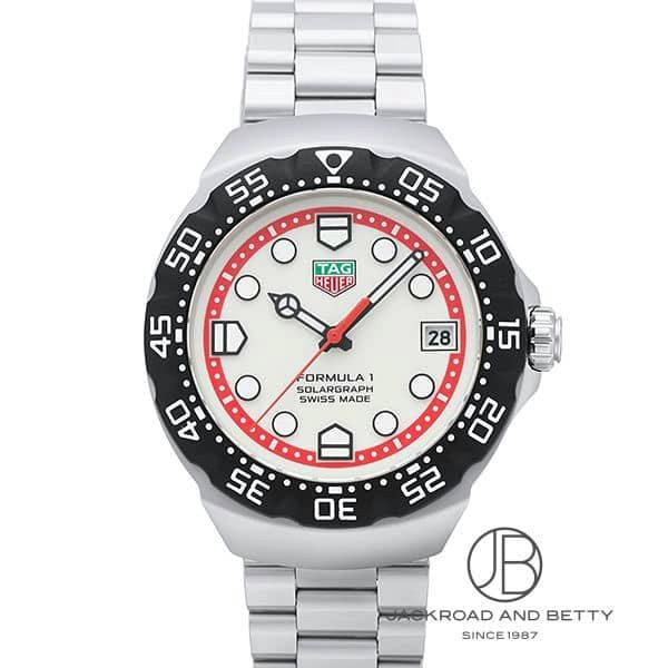 Front view of a TAG HEUER watch with metal case and bracelet, a white dial with a red inner ring, black numbered bezel, and a date window at 3 o'clock.