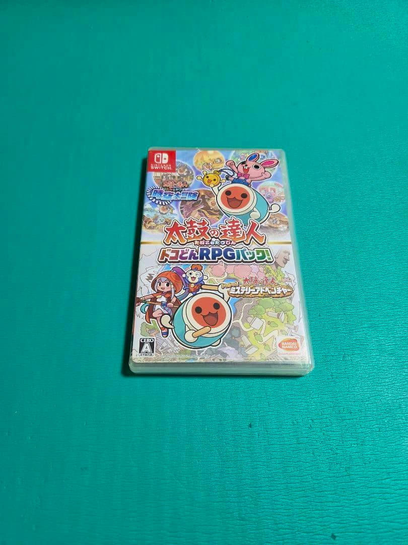 Closed Nintendo Switch game case for 太鼓の達人 ドコどんRPGパック! resting on a teal background.