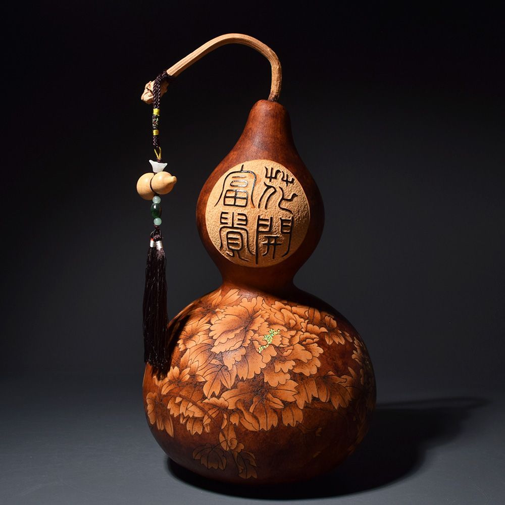 Wooden gourd figure with pyrography characters, floral burn-etch decoration and a hanging tassel.