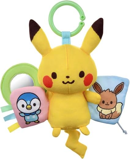 A Pikachu plush toy with a green clip ring and two attached soft fabric accessories depicting Piplup and Eevee.