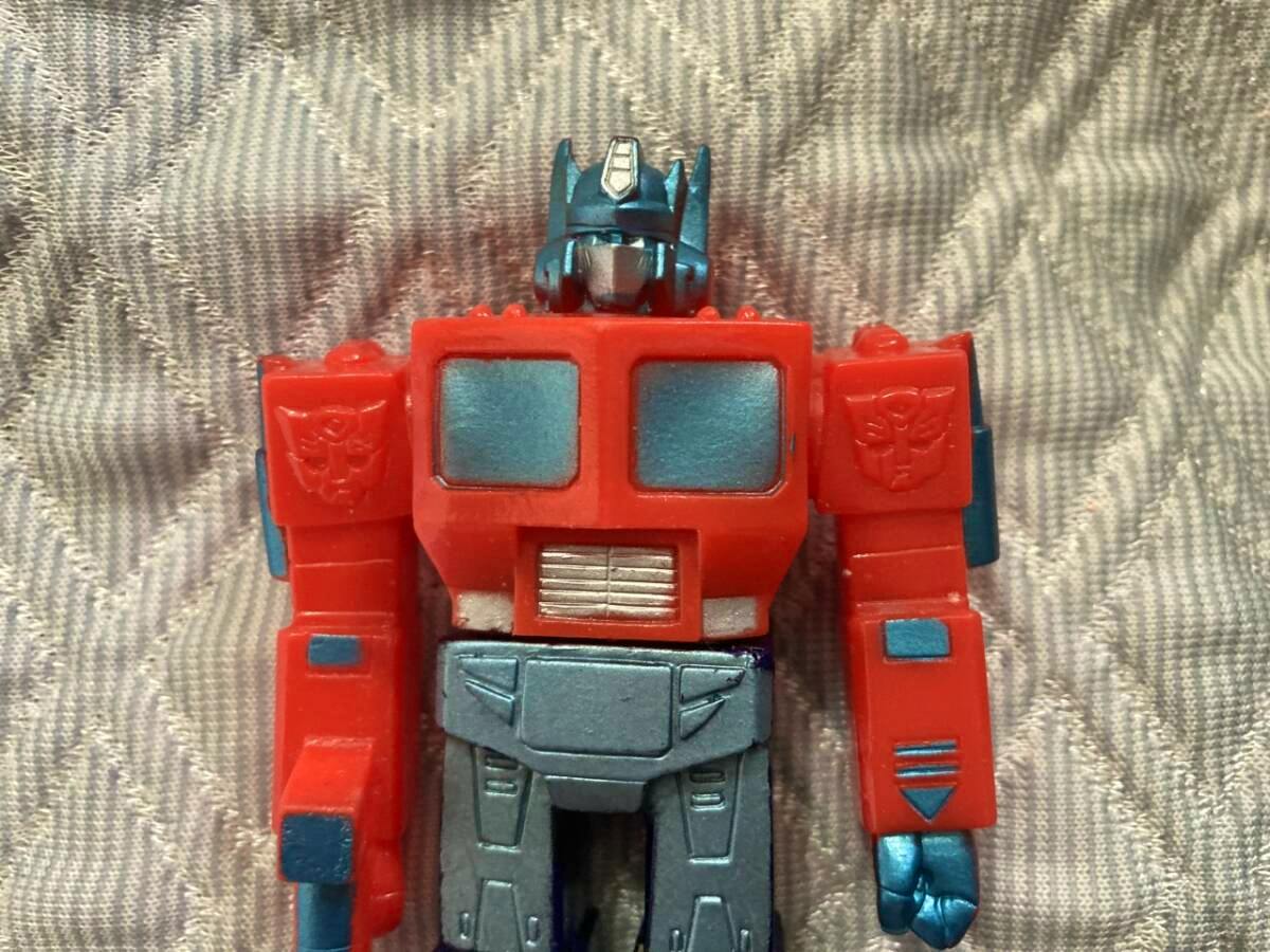 Close-up front view of a red and blue Convoy (Optimus Prime) sofubi figure showing head, torso, and arms.