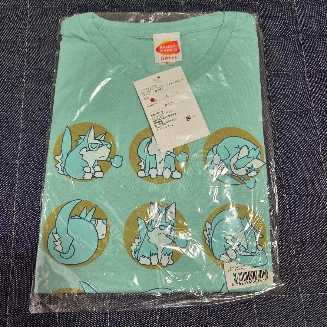 Folded light green Tales of Vesperia Rapido cotton T-shirt in plastic packaging showing character print and a paper tag.