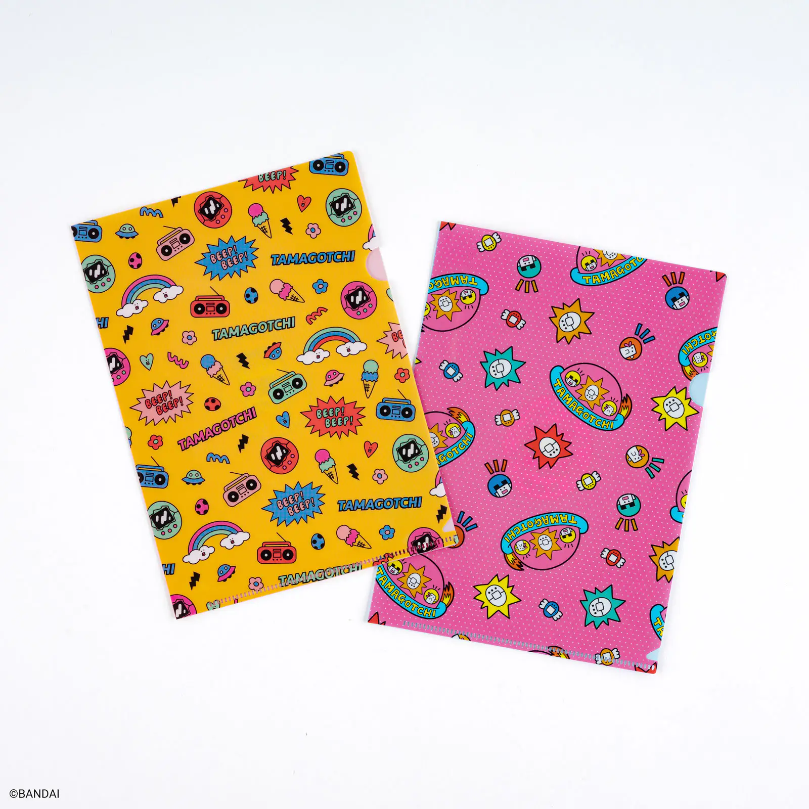 Two A5-size clear file folders with Tamagotchi-themed yellow and pink patterns displayed on a white background.