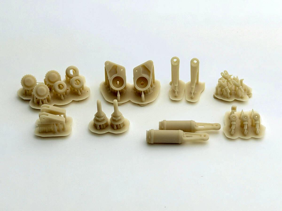 Unpainted beige resin front-suspension detail-up parts for the Tamiya 1/12 Ferrari 641/2 arranged on a white background.