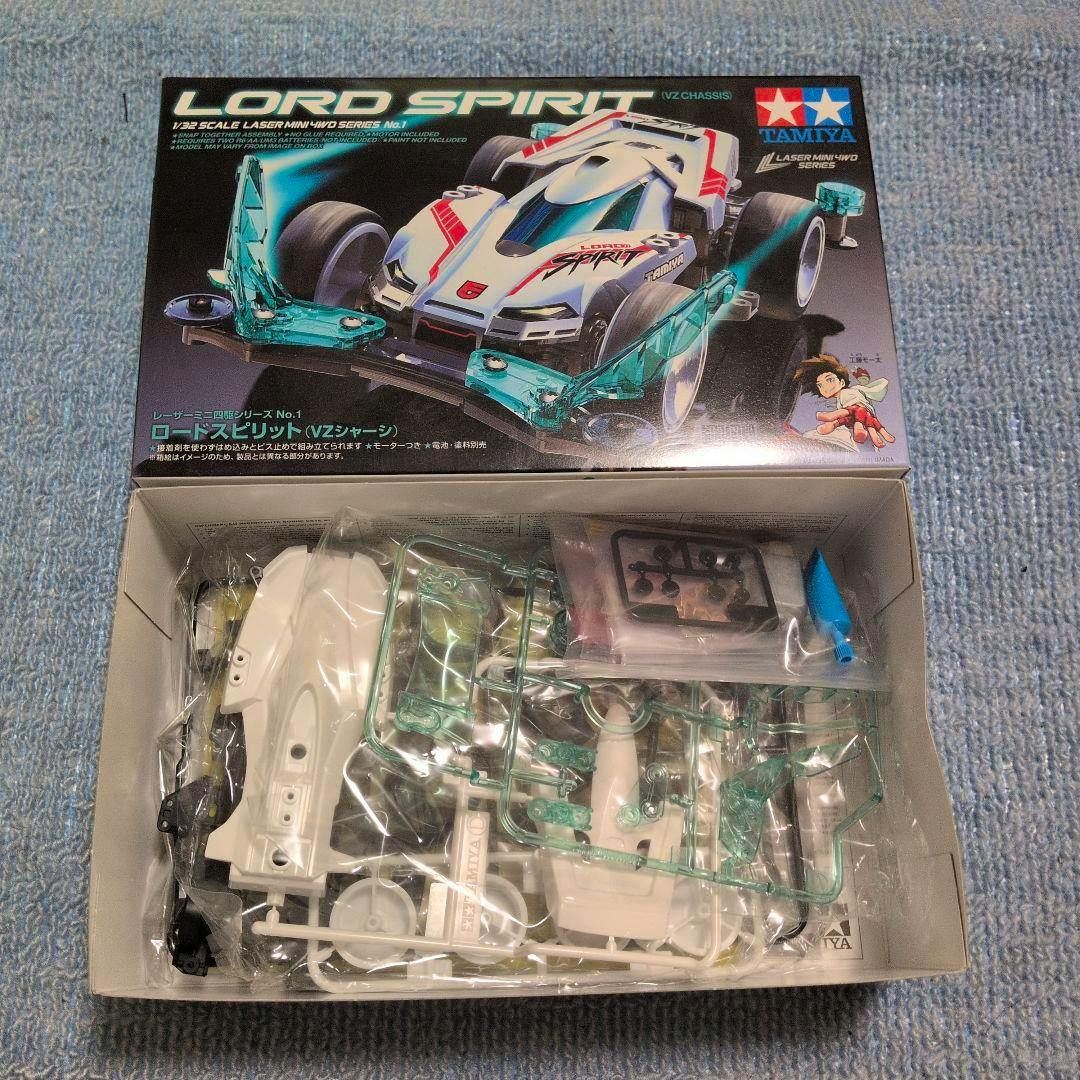 Opened Tamiya Mini 4WD Lord Spirit VZ chassis model kit box showing the box art and plastic sprues and parts inside.