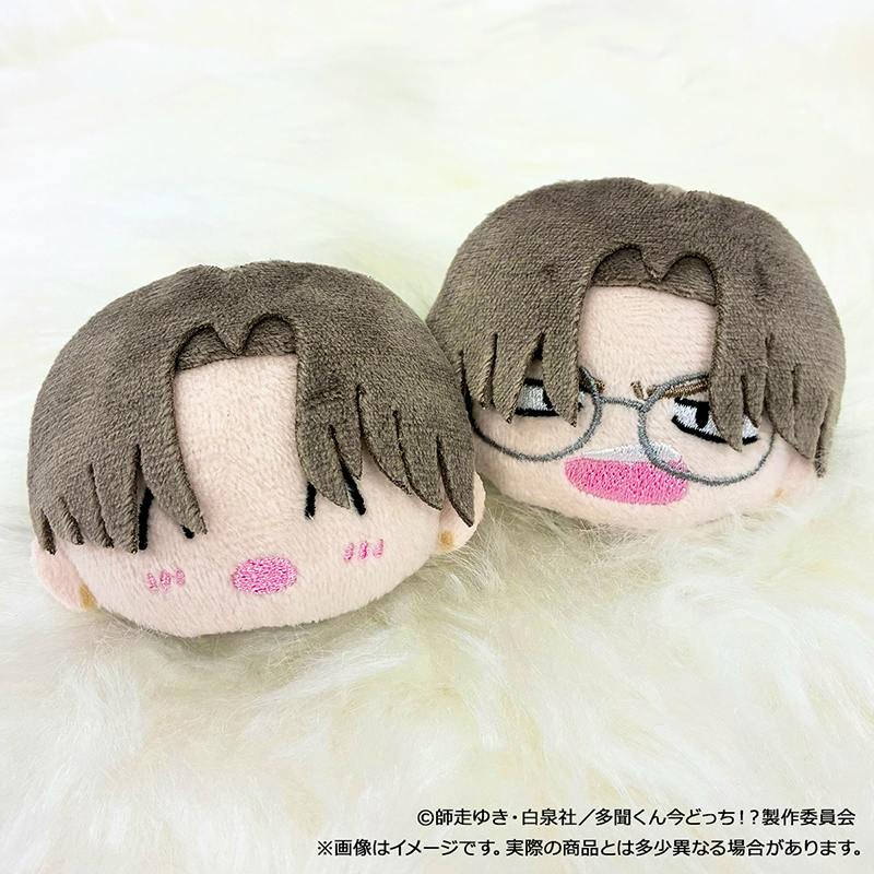 Front view of two plush hair clips with embroidered faces and brown hair, one wearing glasses.
