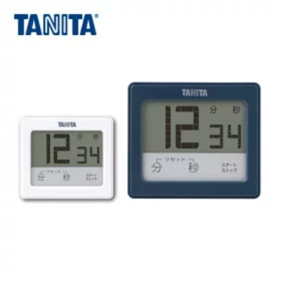 Two TANITA TD-414 digital kitchen timers (white and blue) displaying 12:34 on their screens.