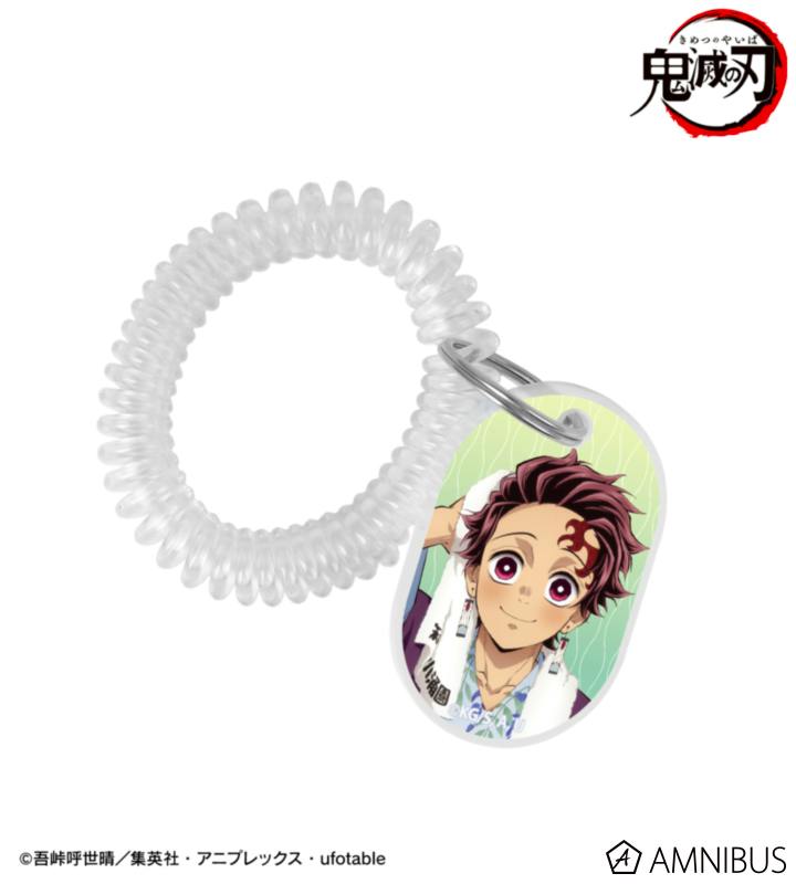 A locker-key-style acrylic keychain showing an illustrated Tanjiro Kamado in an onsen yukata attached to a clear coiled strap.