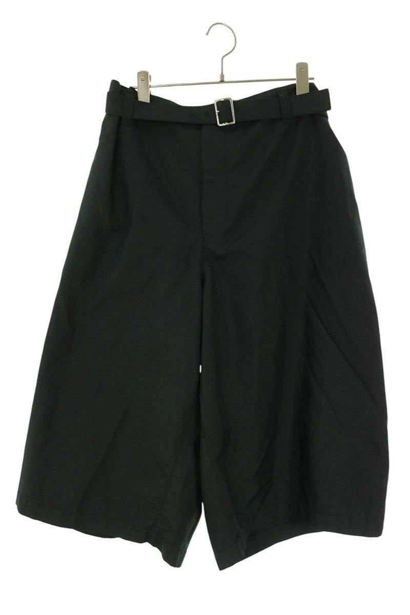 Black volume wide half pants (men's S) with a belt hanging on a hanger against a white background.