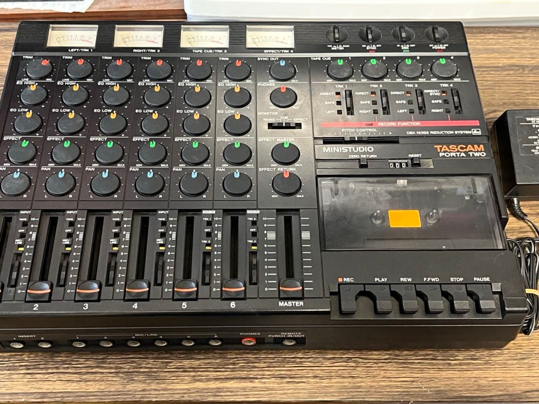Top-down photo of the TASCAM MINISTUDIO PORTA TWO mixer showing faders, knobs, and cassette deck.