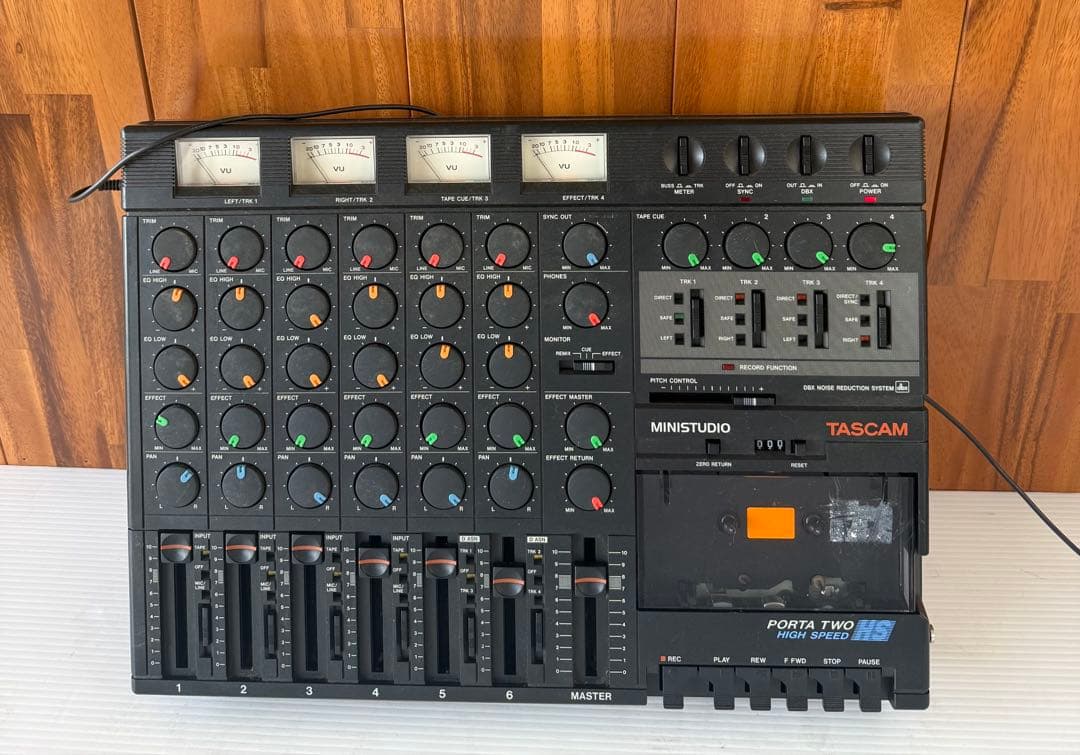 Top-down photo of a TASCAM Porta Two Ministudio cassette MTR showing mixer controls, VU meters, faders, and the cassette compartment.
