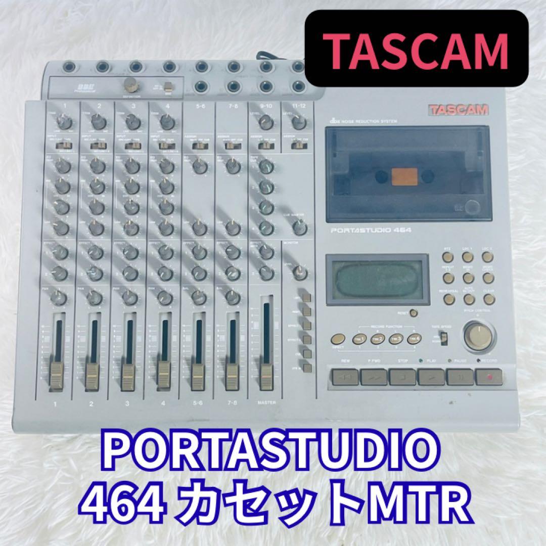 Front view of a TASCAM Portastudio 464 cassette multitrack recorder showing faders, knobs, cassette deck, and display.