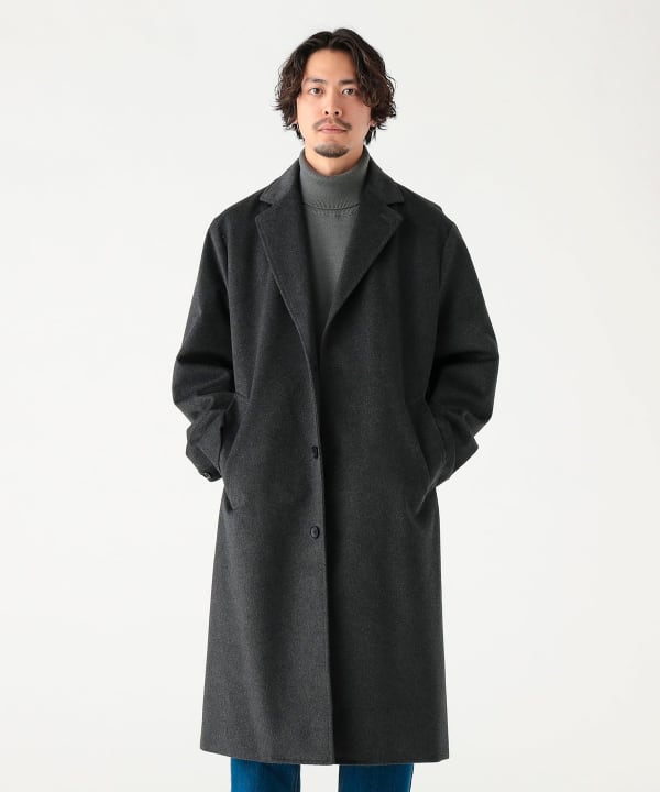 Male model wearing a dark gray Tasmanian wool Chester coat against a white background.