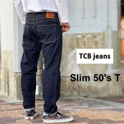 Rear view of a person wearing TCB jeans Slim 50's T denim trousers.