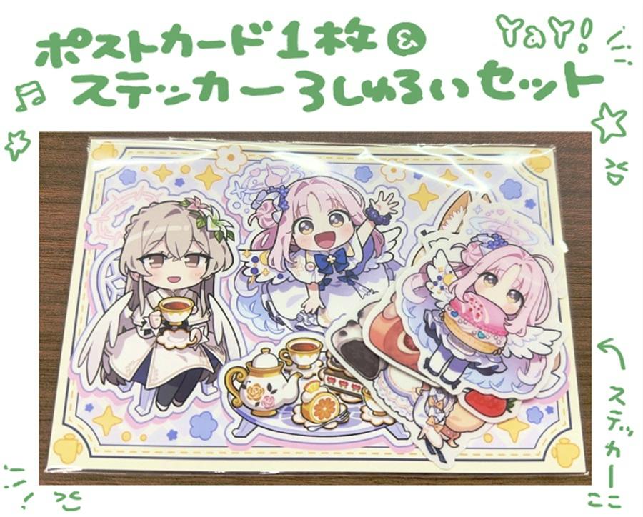 Photograph of the packaged sticker and postcard set showing three chibi character stickers and a decorative postcard on a wooden surface.
