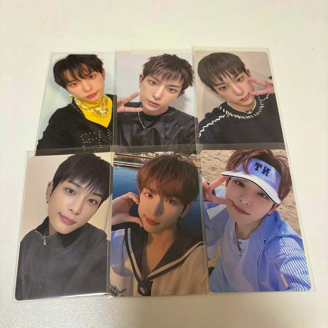 Six portrait photocard images arranged in two rows of three on a white surface, each showing a close-up of a person.