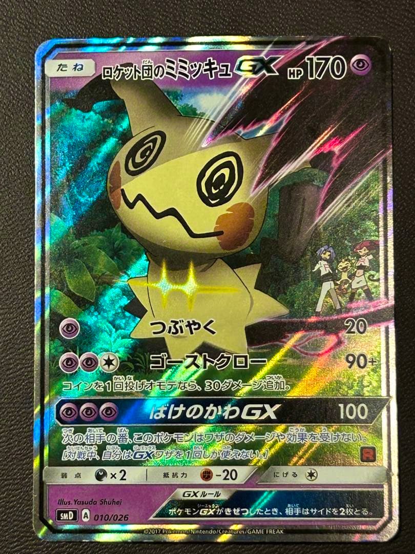 Holographic front of the ロケット団のミミッキュGX Pokémon trading card showing the Mimikyu artwork, Japanese text, HP 170, and attack details.