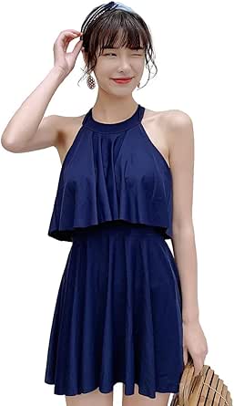 Model wearing a navy high-neck one-piece women's swimsuit with a flared skirt.
