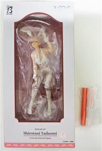 Boxed Ten Count Shirotani Tadaomi figure shown in its windowed packaging with two rolled mini tapestry bonuses alongside.